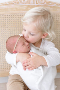 big brother kissing newborn